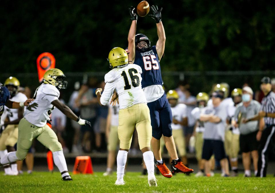 Rochester's Grant Wisecup (65) swats down a pass from Sacred Heart-Griffin quarterback Ty Lott (16) in the second half at Rocket Booster Stadium in Rochester, Ill., Friday, September 10, 2021. [Justin L. Fowler/The State Journal-Register] 