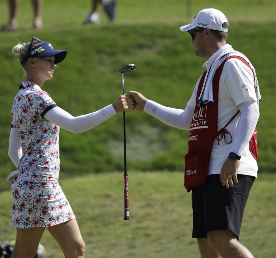 Madelene Sagstrom, left, of Sweden, fists-bumps her caddie after saving par on the eighth hole during the final round of the Pure Silk Championship golf tournament at Kingsmill Resort in Williamsburg, Va., Sunday, May 26, 2019. (AP Photo/Steve Helber)