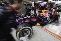 Red Bull Racing driver Sebastian Vettel of Germany is pushed into the garage during the practice session ahead of Sunday's Chinese Formula One Grand Prix at Shanghai International Circuit in Shanghai, China, Saturday, April 19, 2014. (AP Photo/Alexander F. Yuan)