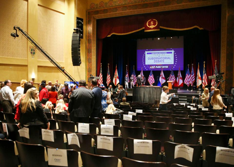 Audience members fill the Sunrise Theatre ahead of a debate between Florida Republican Gov. Ron DeSantis and his Democratic opponent Charlie Crist in Fort Pierce, Fla., Monday, Oct. 24, 2022.