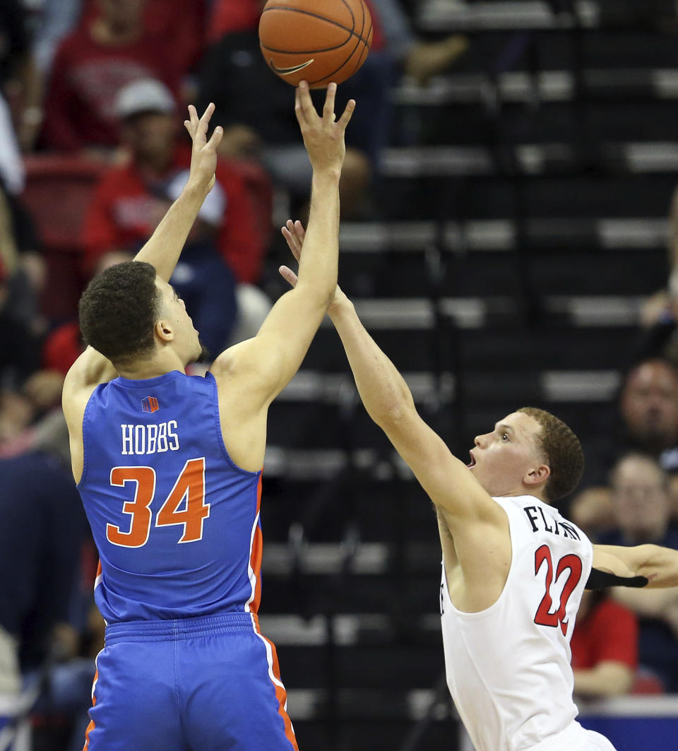 Boise State's Alex Hobbs (34) shoots as San Diego State's Malachi Flynn (22) defends during the second half of an NCAA college basketball game in the Mountain West Conference men's tournament Friday, March 6, 2020, in Las Vegas. (AP Photo/Isaac Brekken)