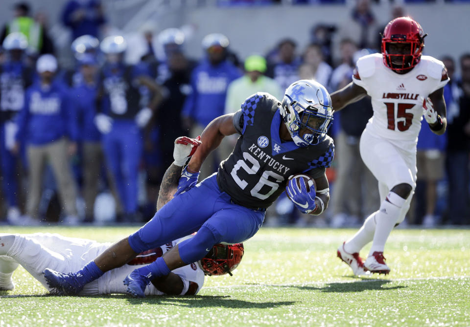 Kentucky running back Benny Snell Jr. is tackled by Louisville cornerback Jaire Alexander. (AP Photo)