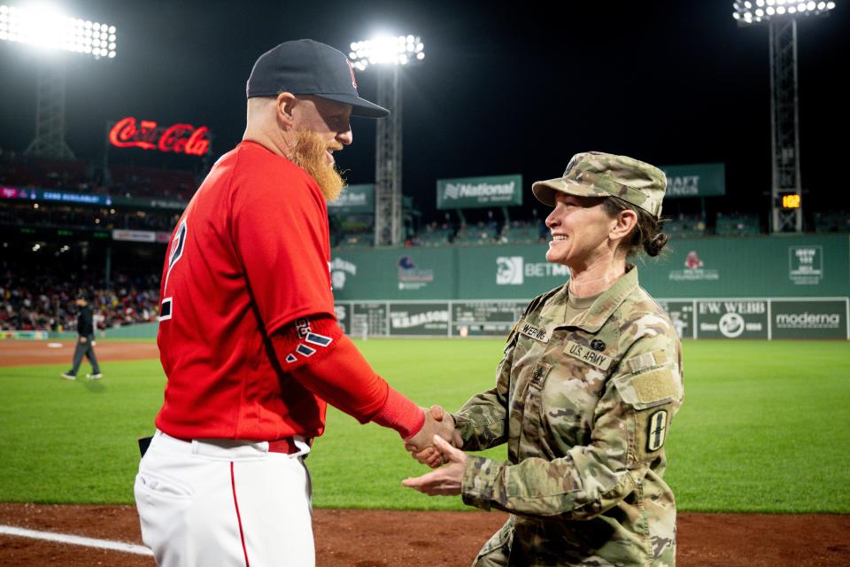 1st Sgt. Arian Rita Wering greets Justin Turner of the Boston Red Sox after being recognized during the Hats Off To Heroes ceremony during the fourth inning of a home game between the Boston Red Sox and the Minnesota Twins.
