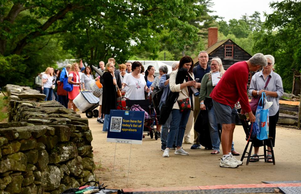 STURBRIDGE -  Bearing bags and boxes, fortune hunters wait in the “Antiques Roadshow” triage line for their chance to get their items appraised at Old Sturbridge Village on Tuesday.