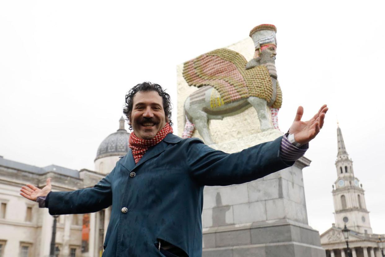 Iraqi-American artist Michael Rakowitz poses in front of his sculpture 'The Invisible Enemy Should Not Exist' standing on the Fourth Plinth in Trafalgar Square: AFP/Getty Images