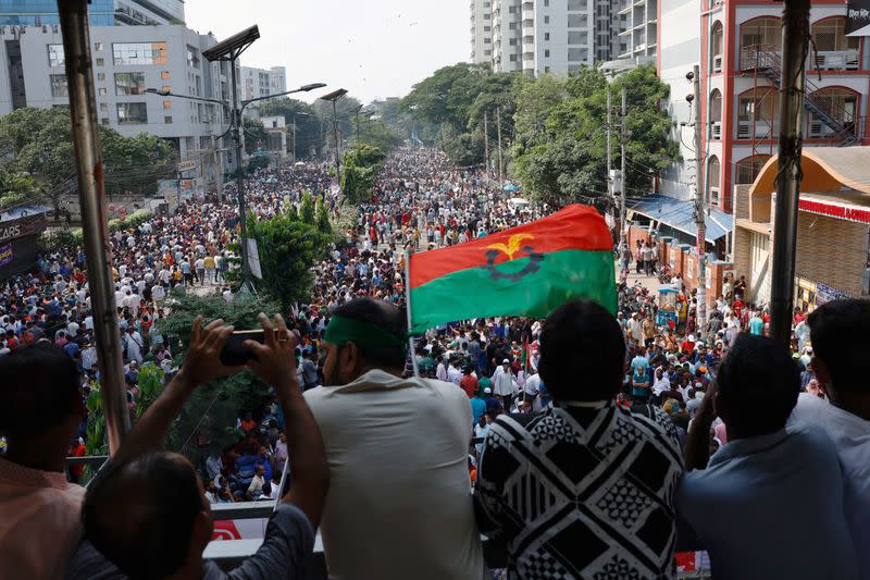 Supporters of Bangladesh Nationalist Party (BNP) wave party flag during a rally at Naya Paltan area in Dhaka