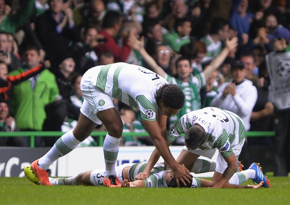 Celtic's Virgil van Dijk (L) and Mikael Lustig (R) congratulate Beram Kayal on his goal against Ajax during their Champions League soccer match at Celtic Park Stadium, Scotland October 22, 2013. REUTERS/Russell Cheyne (BRITAIN - Tags: SPORT SOCCER)