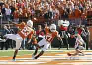 AUSTIN, TX - NOVEMBER 5: Cornerbacks Carrington Byndom #23 and Adrian Phillips #17 of the Texas Longhorns break up a first quarter touchdown pass to wide receiver Austin Zouzalik #6 of the Texas Tech Red Raiders on November 5, 2011 at Darrell K. Royal-Texas Memorial Stadium in Austin, Texas. (Photo by Erich Schlegel/Getty Images)