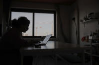 Nouhaila Fakhor from Morocco, a student of commerce, studies in her student housing in Ivry sur Seine, outside Paris, Thursday, Feb. 11, 2021. A quarter of French young professionals can't find work, and many university students are standing in food lines or calling hotlines for psychological help. They are France's future, and their plight is central to the country's battle to emerge from the pandemic. (AP Photo/Christophe Ena)