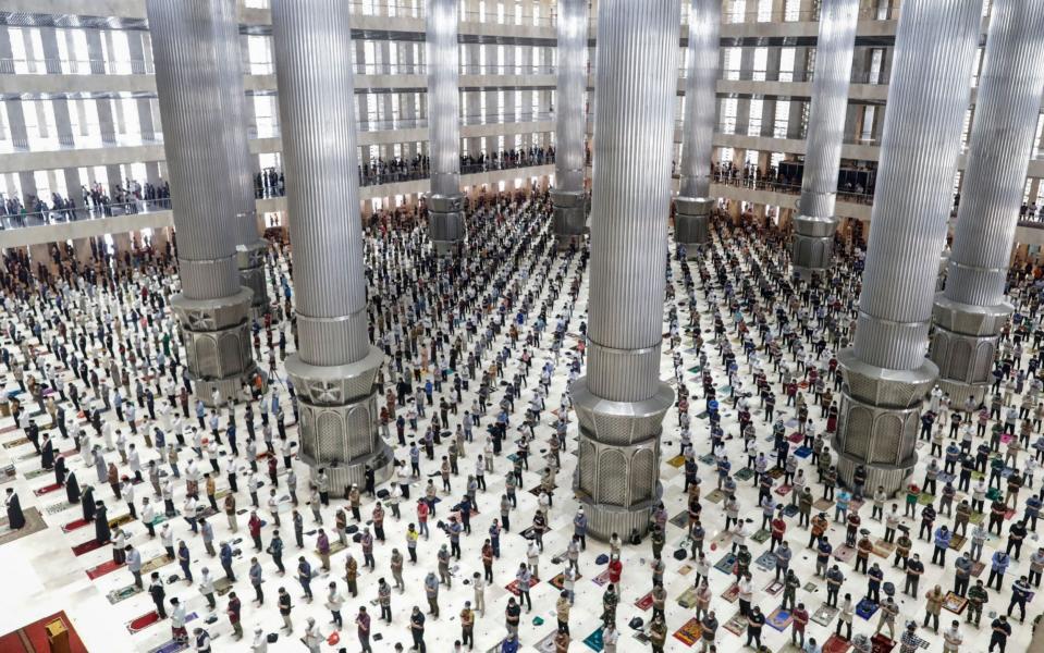 Muslims pray space apart to curb the spread of the coronavirus during Friday prayers on the holy fasting month of Ramadan at Istiqlal grand mosque in Jakarta, Indonesia - MAST IRHAM/EPA-EFE/Shutterstock