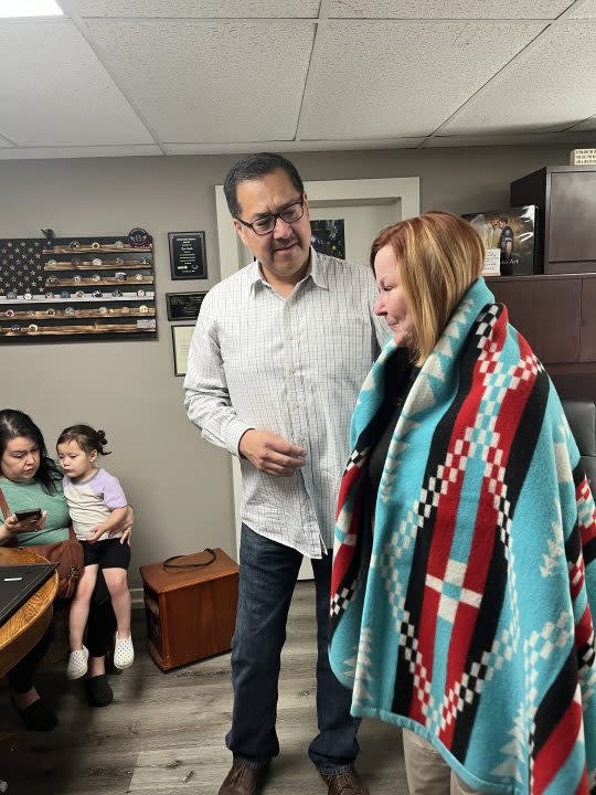 Howe family presents Arkansas City Fire/EMS Director Jeri Wheatley with Ponca tribal blanket for saving 2-year-old Luna (courtesy Arkansas City)