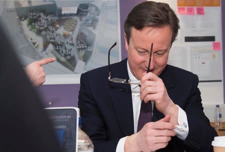 Britain's Prime Minister David Cameron talks to members of Sainsbury's digital development team at their headquarters during a general election campaign visit, in London March 31, 2015. REUTERS/Leon Neal/Pool