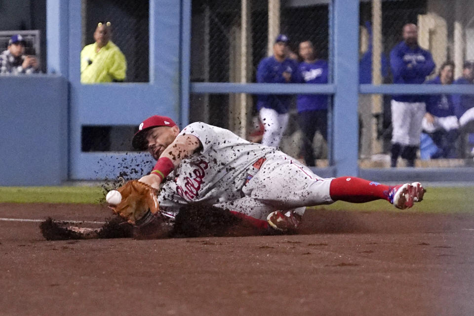 Philadelphia Phillies left fielder Kyle Schwarber can't get to a foul ball hit by Los Angeles Dodgers' Freddie Freeman during the third inning of a baseball game Friday, May 13, 2022, in Los Angeles. (AP Photo/Mark J. Terrill)