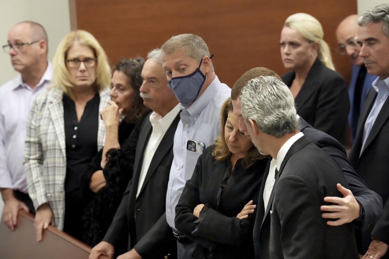 Caryn DeSacia Schachter, third from left, her step-son, Ryan, and fiancé, Max Schachter, embrace after giving their victim impact statements during the penalty phase of the trial of Marjory Stoneman Douglas High School shooter Nikolas Cruz at the Broward County Courthouse in Fort Lauderdale, Fla., Wednesday, Aug. 3, 2022. The Schachter's son, Alex, was killed in the 2018 shootings. Cruz previously plead guilty to all 17 counts of premeditated murder and 17 counts of attempted murder in the 2018 shootings. (Amy Beth Bennett/South Florida Sun Sentinel via AP, Pool)