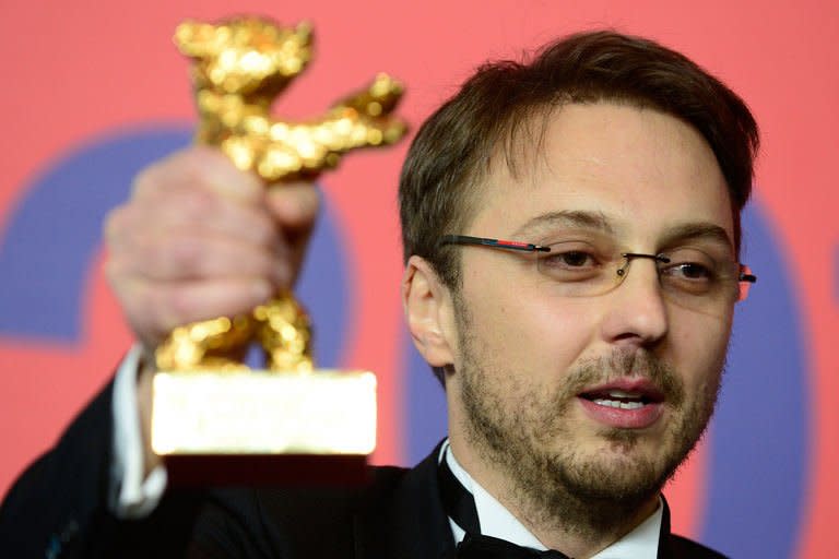 Romanian director Calin Peter Netzer poses with his Golden Bear for the Best Film he received for the movie "Pozitia Copilului" ("Child's Pose") during a press conference following the awards ceremony in Berlin on February 16, 2013