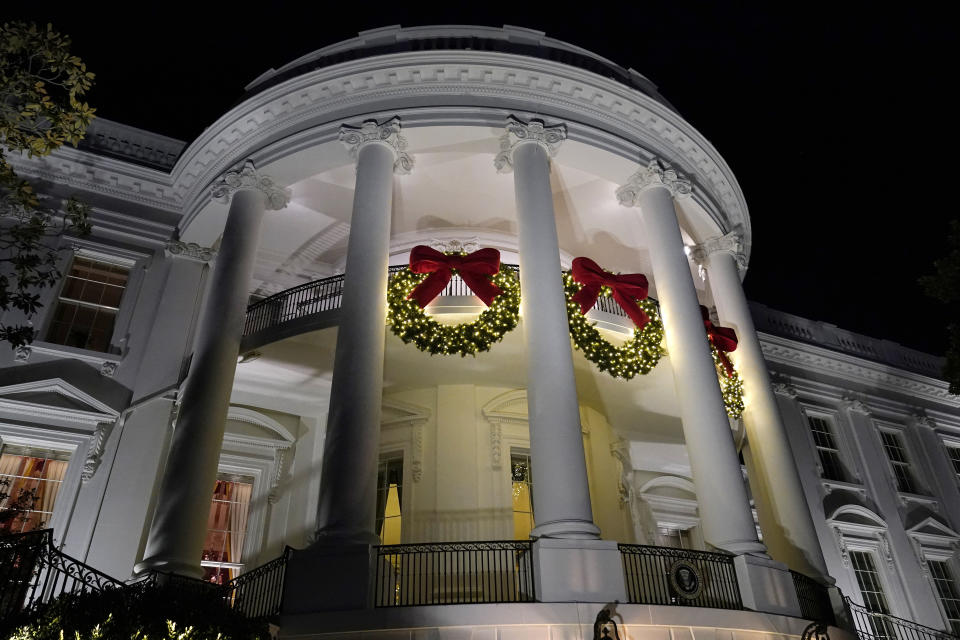 FILE - A view of the South balconies of the White House in Washington Nov. 30, 2021, lit up with holiday decorations. In addition to fewer people passing through the White House for the open houses, thousands of other people didn't get a close-up look at how Jill Biden decked out White House hallways and public rooms for the holidays because public tours of the executive mansion remain on indefinite hold due to COVID-19. (AP Photo/Susan Walsh, File)