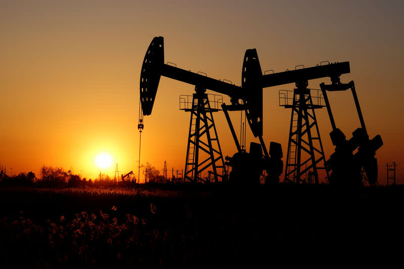 Pumpjacks are seen against the setting sun at the Daqing oil field in Heilongjiang province, China December 7, 2018. REUTERS/Stringer/Files