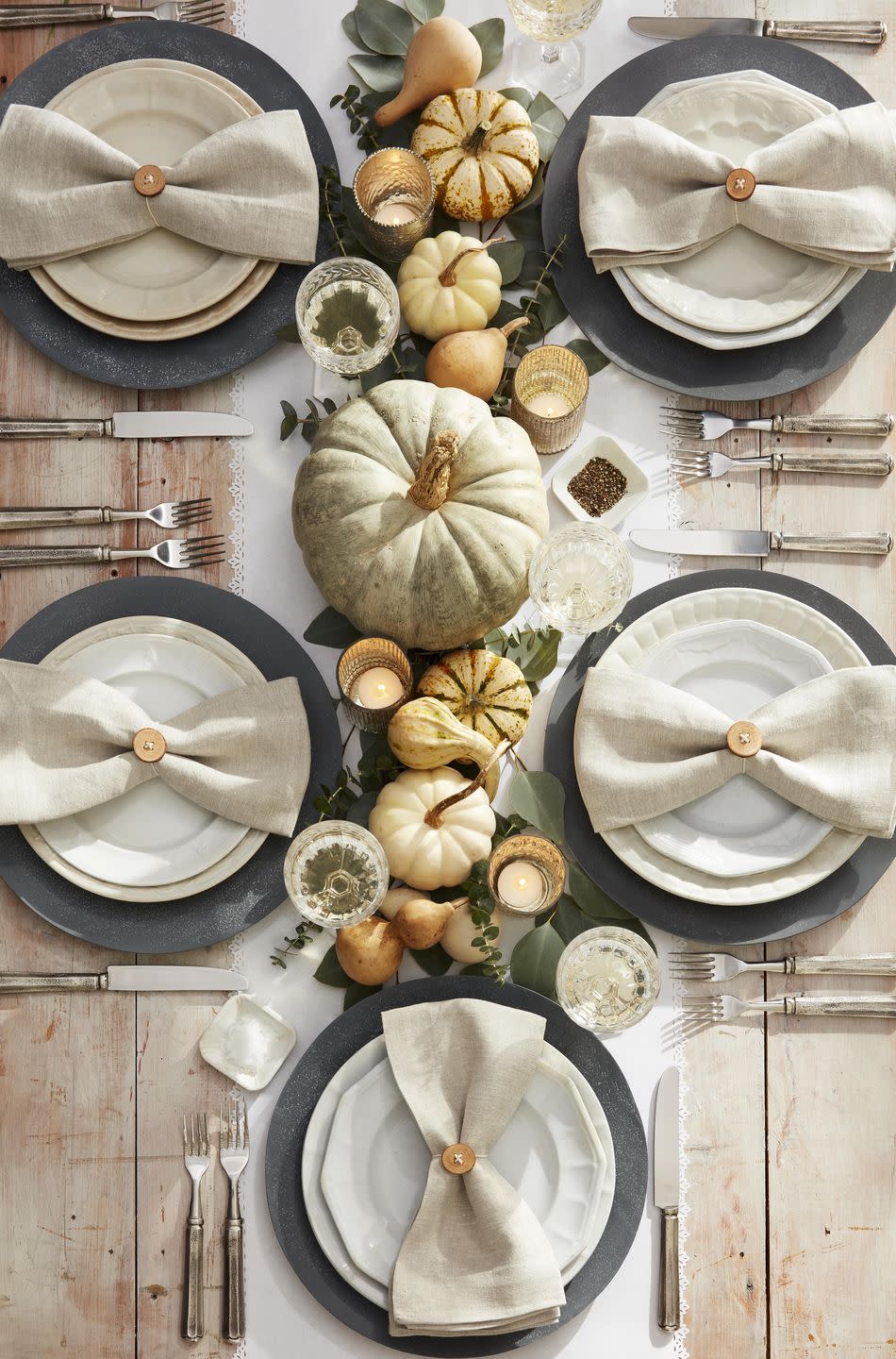 <p>For a neutral yet bountiful tablescape simply line the center of the table with eucalyptus branches, neutral pumpkins and gourds, and painted pumpkins (see next slide). For a warm touch but votive candles in sparkly gold glass holders.<br><br><a class="link " href="https://www.amazon.com/Just-Artifacts-Speckled-Mercury-Tealight/dp/B01D1ZCPIA/ref=sr_1_3_sspa?tag=syn-yahoo-20&ascsubtag=%5Bartid%7C10050.g.2063%5Bsrc%7Cyahoo-us" rel="nofollow noopener" target="_blank" data-ylk="slk:SHOP GOLD VOTIVE HOLDERS;elm:context_link;itc:0;sec:content-canvas">SHOP GOLD VOTIVE HOLDERS</a></p>