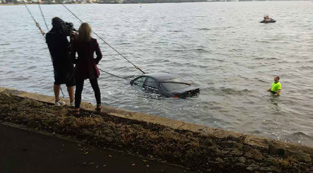 A crane was called in to lift the car out of the water. Source: WA Police Traffic