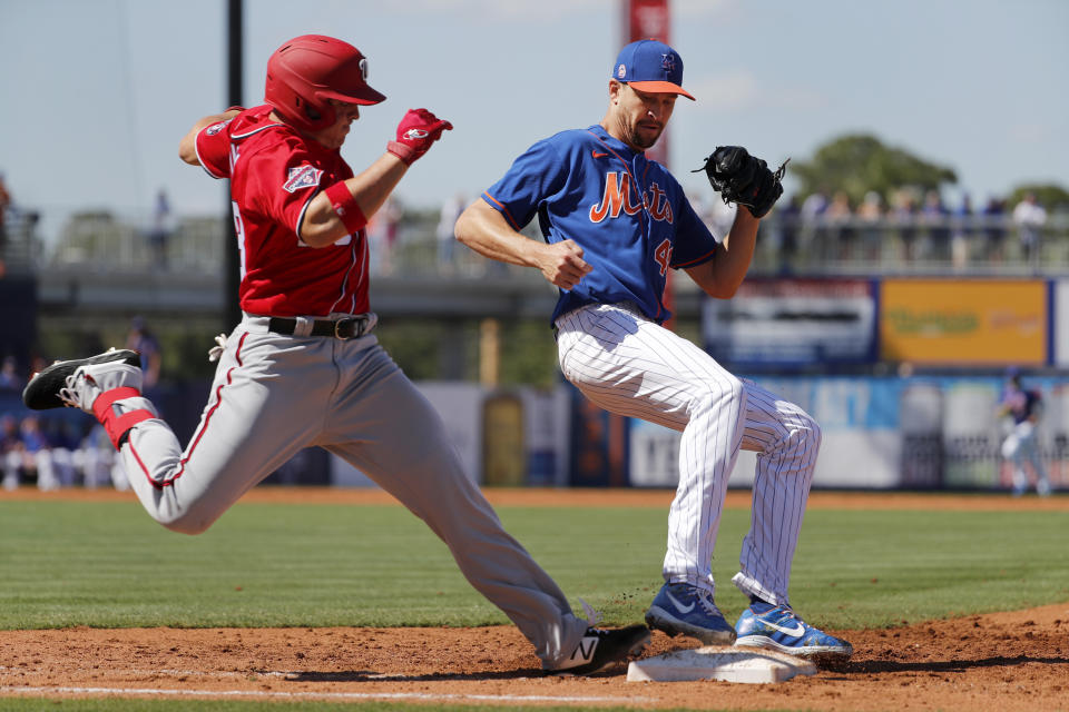 New York Mets pitcher Jacob deGrom, right, forces Washington Nationals' JB Shuck out at first base to end the top of the third inning of a spring training baseball game Sunday, March 1, 2020, in Port St. Lucie, Fla. (AP Photo/Jeff Roberson)