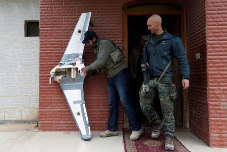 U.S. Special Operations Forces members inspect a drone used by Islamic State militants to drop explosives on Iraqi forces, in Mosul. REUTERS/Muhammad Hamed