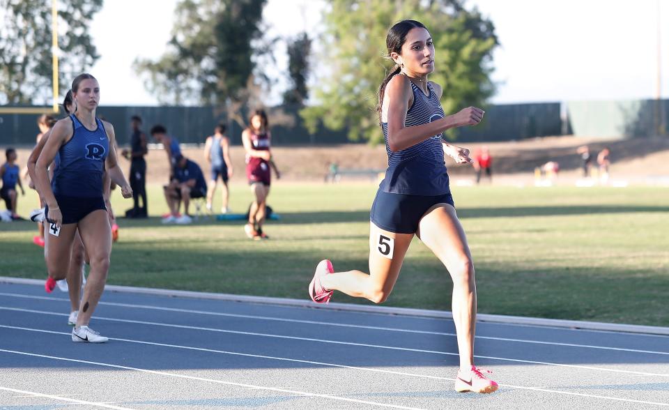 Redwood's Graycie Serpa leads the field by a wide margin for the win in the 200 meters during the 2024 East Yosemite League high school track and field championships at Golden West High School in Visalia, Calif., Friday, May 3, 2024.