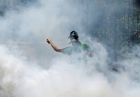 A Palestinian protester hurls stones towards Israeli troops as he reacts to tear gas during clashes following a protest in solidarity with Palestinian prisoners held by Israel, in the West Bank town of Bethlehem April 17, 2017. REUTERS/Ammar Awad