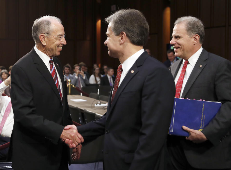 Chuck Grassley, left, shakes hands with Christopher Wray