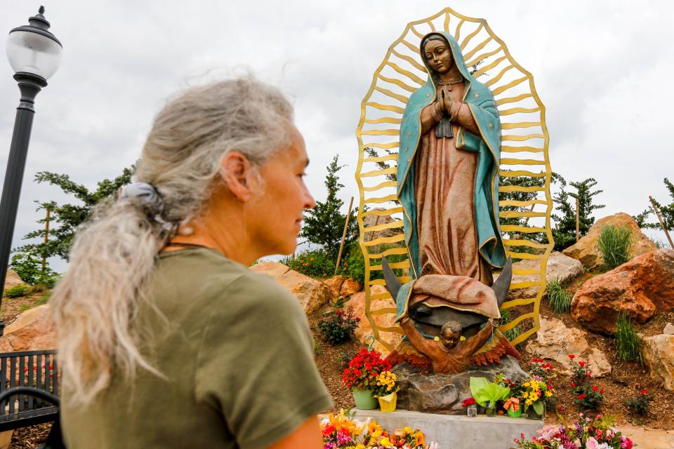 After participating in a pilgrimage walk from Moore to the Blessed Stanley Rother Shrine on Thursday, Anna Arra stands in from of a statue of Our Lady of Guadalupe atop Tepeyac Hill on the grounds of the shrine, 700 SE 89.