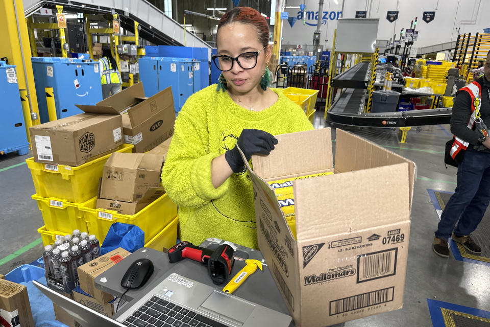 File - A worker handles a carton at an Amazon same-day delivery shipping center in Woodland Park, New Jersey, on Dec. 18, 2023. Amazon releases results on Thursday, Feb. 1, 2024. (AP Photo/Ted Shaffrey, File)