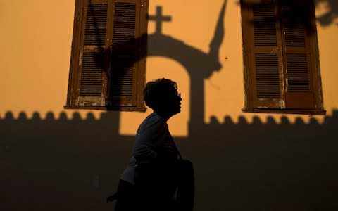 The new law on gender declaration has been fiercely opposed by the Greek Orthodox Church. The shadow of a church is seen in Plaka, a historic district of Athens. - Credit: AP