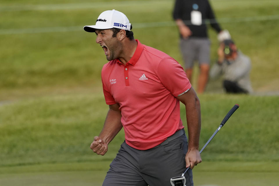 Jon Rahm reacts after making his putt on the first playoff hole during the final round of the BMW Championship golf tournament at the Olympia Fields Country Club in Olympia Fields, Ill., Sunday, Aug. 30, 2020. (AP Photo/Charles Rex Arbogast)