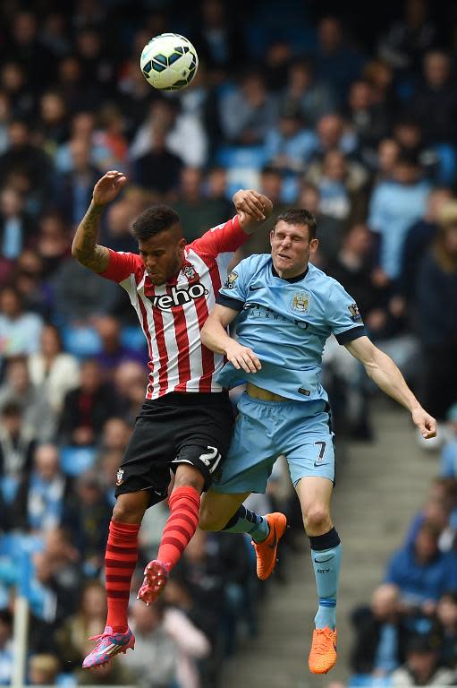 Manchester City's English midfielder James Milner (R) vies with Southampton's English defender Ryan Bertrand (L) during the English Premier League football match in Manchester, northwest England on May 24, 2015