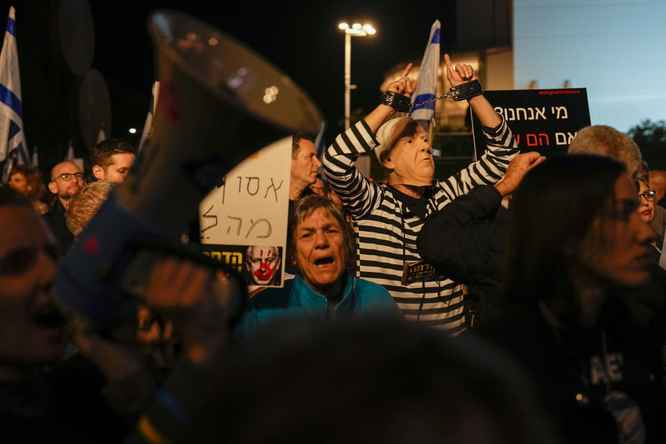 FILE - Israelis protest against Prime Minister Benjamin Netanyahu's government in Tel Aviv, Israel, Saturday, Dec. 30, 2023. Critics say Israeli Prime Minister Benjamin Netanyahu is increasingly using his perch as wartime leader to improve his political fortunes. (AP Photo/Ariel Schalit, File)