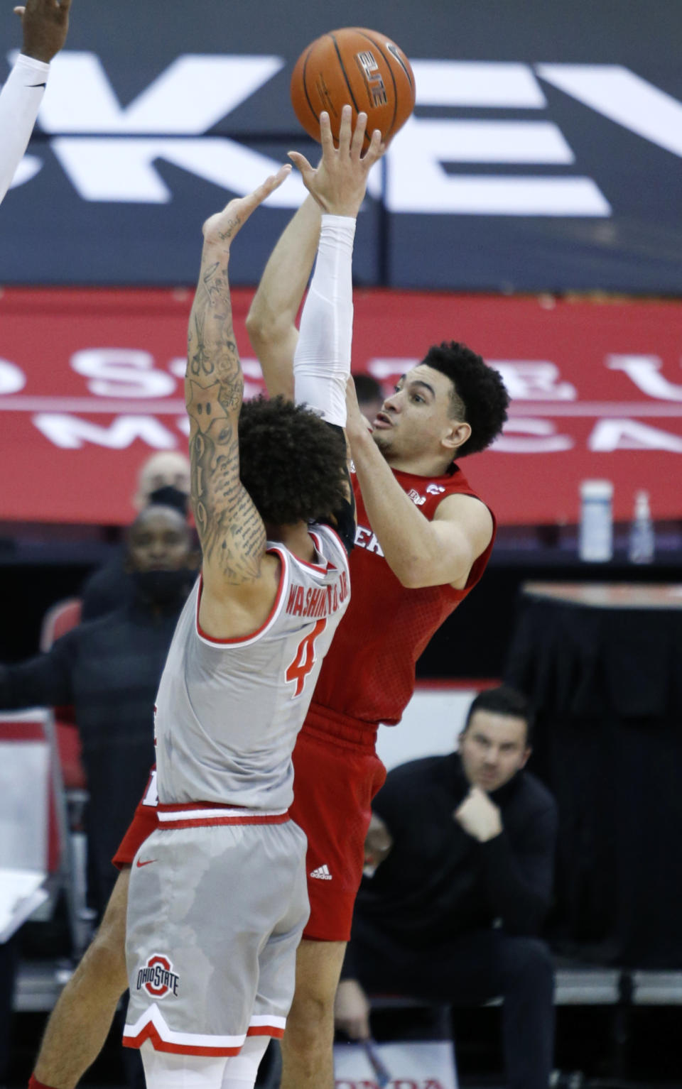 Rutgers guard Geo Baker, right, goes up for a shot against Ohio State guard Duane Washington during the first half of an NCAA college basketball game in Columbus, Ohio, Wednesday, Dec. 23, 2020. (AP Photo/Paul Vernon)