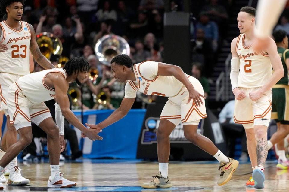 Mar 21, 2024; Charlotte, NC, USA; Texas Longhorns forward Dillon Mitchell (23), Texas Longhorns guard Tyrese Hunter (4), Texas Longhorns guard Max Abmas (3), and Texas Longhorns guard Chendall Weaver (2) celebrate a play in the first half of the first round of the 2024 NCAA Tournament at Spectrum Center.
