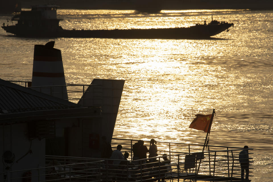 In this April 8, 2020, photo, passengers onboard a ferry wait to cross the Yangtze River in Wuhan in central China's Hubei province. The reopening of ferry service on the Yangtze River, the heart of life in Wuhan for more than 20 centuries, was an important symbolic step in official efforts to get business and daily life in this central Chinese city of 11 million people back to normal after a 76-day quarantine ended in the city at the center of the coronavirus pandemic. (AP Photo/Ng Han Guan)