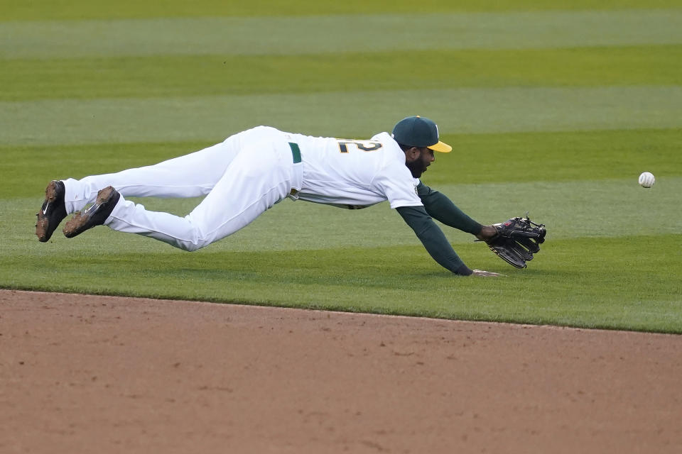 Oakland Athletics shortstop Elvis Andrus cannot field a base hit by Detroit Tigers' Robbie Grossman during the third inning of a baseball game in Oakland, Calif., Thursday, April 15, 2021. (AP Photo/Jeff Chiu)