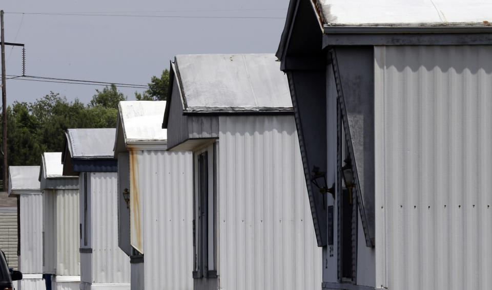 This photo taken Wednesday, May 29, 2019 shows a row of homes at the Alamac Time Out mobile home community in Lumberton, N.C. Over the past two years, Time Out Communities has bought 21 properties in the Robeson County, a low income-county that was one of the hardest-hit in hurricanes Matthew and Florence. Mobile home residents in Robeson County, North Carolina are seeing increasing rent prices after being slammed by hurricanes Matthew and Florence.(AP Photo/Gerry Broome)