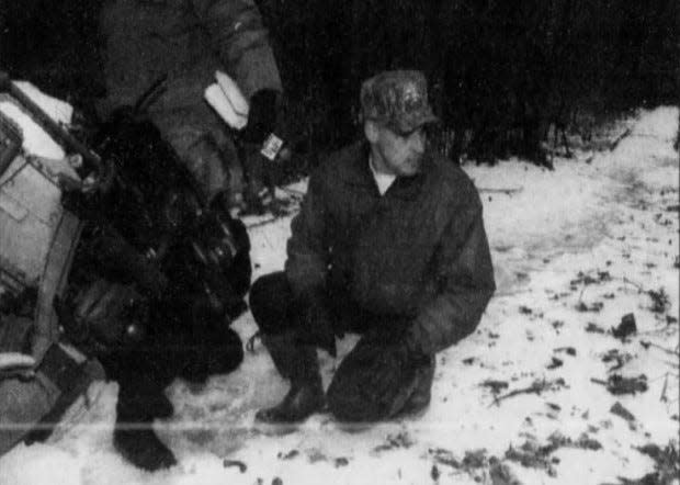 New Castle County Police Cpl. Butch Lefebvre examines cougar tracks in 1996. Lefebvre led an effort to catch cougars.