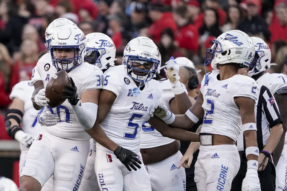 Tulsa linebacker Justin Wright (30) celebrates with teammates after recovering a fumble during the second half of an NCAA college football game against Cincinnati Saturday, Nov. 6, 2021, in Cincinnati. (AP Photo/Jeff Dean)