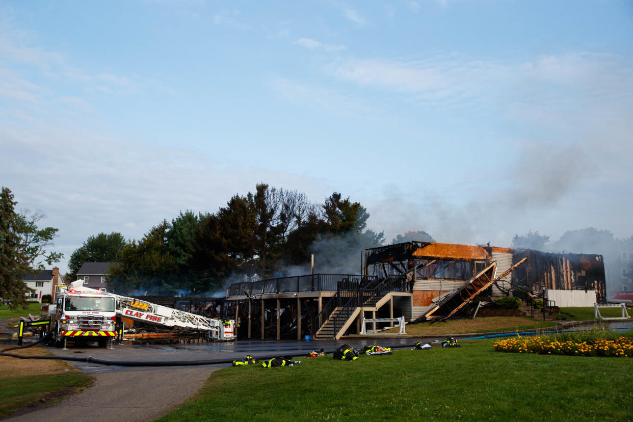 Firefighters work to put out a fire at the Juday Creek Golf Course clubhouse on Monday, Aug. 26, 2024, in Granger.