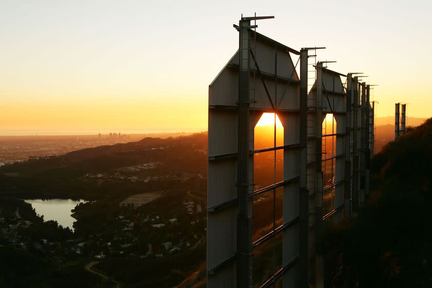 LOS ANGELES, CA - NOVEMBER 16: Day turns to night at the Hollywood Sign on November 16, 2005 in Los Angeles, California. The historic landmark is undergoing a month-long makeover; erected in 1923 as a giant ad for a housing development and originally read "Hollywoodland", the sign with letters that are 45 feet tall and 36 feet wide was declared a Los Angeles Cultural Historical Monument in 1973. (Photo by David McNew/Getty Images)