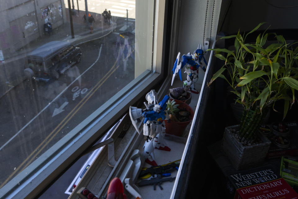 People talk on the street down below Cheyenne Welbourne's micro-apartment at The Starlight affordable housing building that is run by Central City Concern, a Portland-based homeless services nonprofit, on Friday, March 15, 2024, in Portland, Ore. Welbourne moved into one of the nonprofit's single room occupancy units in downtown Portland last March after years of living on the streets. (AP Photo/Jenny Kane)