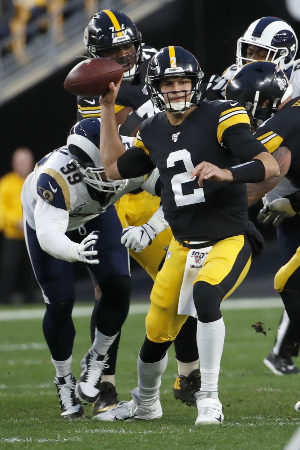 Pittsburgh Steelers quarterback Mason Rudolph (2) prepares to pass under pressure by Los Angeles Rams defensive tackle Aaron Donald (99) during the first half of an NFL football game in Pittsburgh, Sunday, Nov. 10, 2019. (AP Photo/Don Wright)