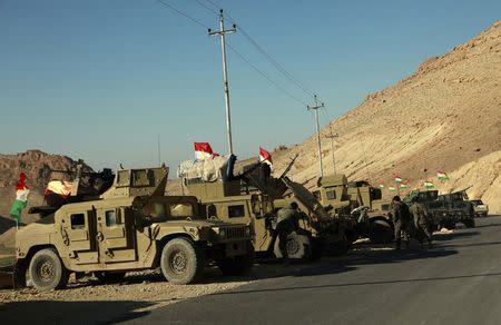 Military vehicles of Kurdish security forces are seen at Mount Sinjar, in the town of Sinjar, December 21, 2014. REUTERS/Ari Jalal