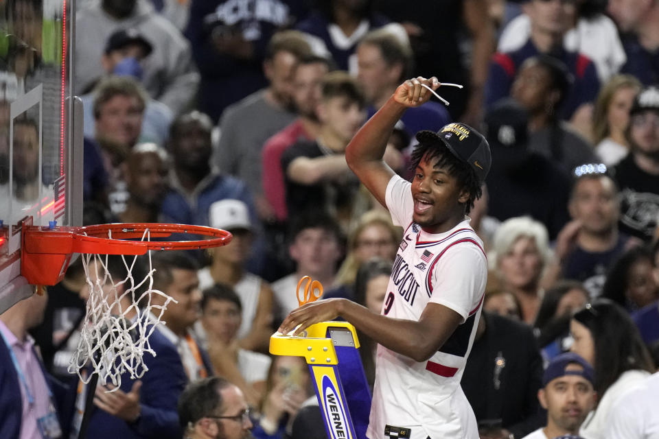 Connecticut guard Tristen Newton cuts down the net after defeating San Diego State in the men's national championship college basketball game in the NCAA Tournament on Monday, April 3, 2023, in Houston. Connecticut won 76-59. (AP Photo/Godofredo A. Vasquez)