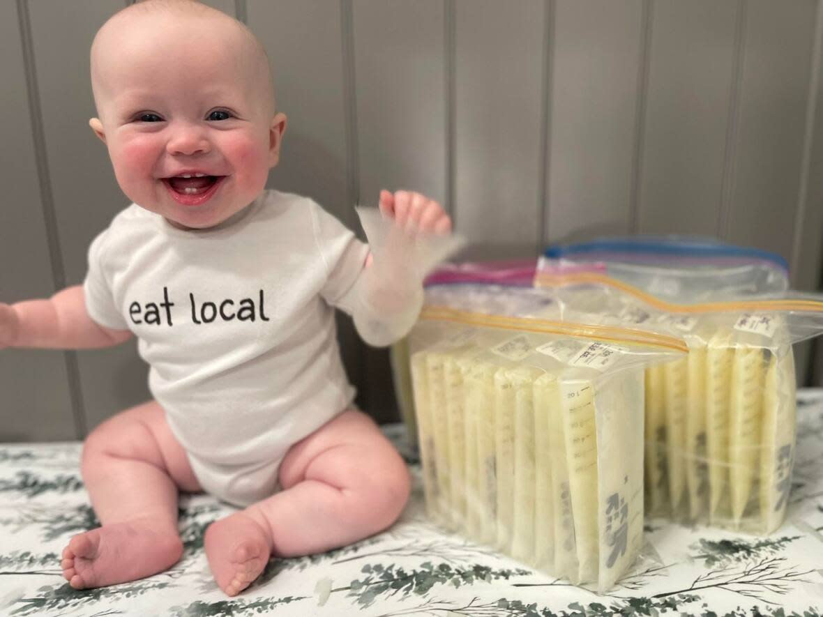 Cole Doyle, Kristina Landry's son, seated next to her latest donation of breast milk.  (Submitted by Kristina Landry - image credit)