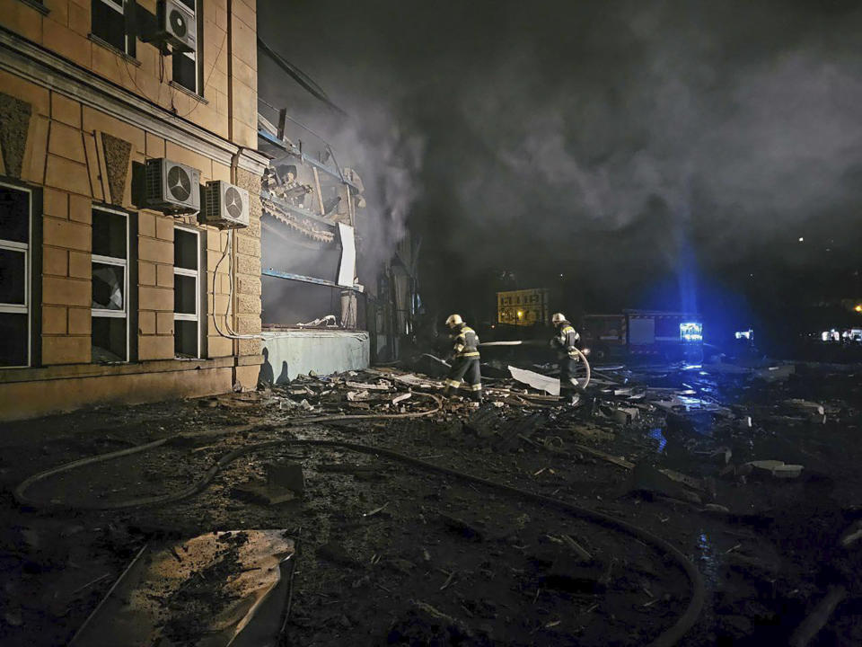 In this photo provided by Odesa City Administration, Ukrainian emergency workers examine the site of a Russian rocket attack in central Odesa, Ukraine, early hours on Monday, Nov. 6, 2023. (Odesa City Administration via AP)