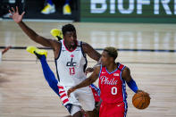 Washington Wizards center Thomas Bryant (13) defends Philadelphia 76ers guard Josh Richardson (0) during the second half of an NBA basketball game Wednesday, Aug. 5, 2020 in Lake Buena Vista, Fla. (AP Photo/Ashley Landis)